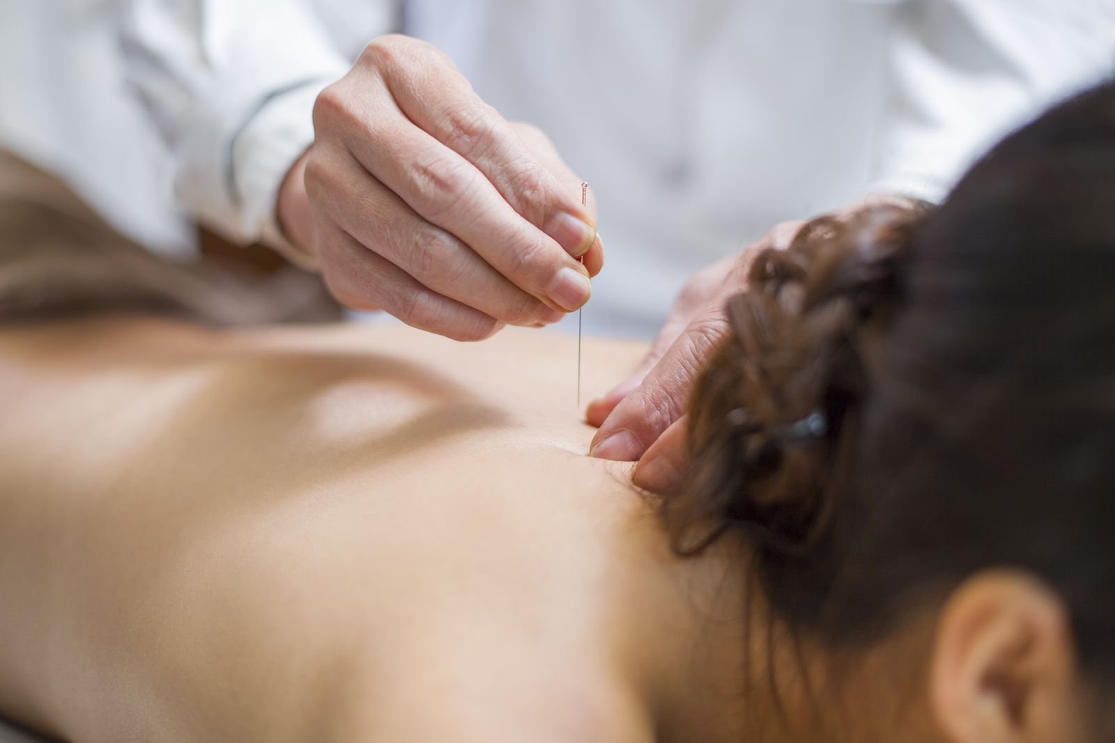 Manual therapy for the upper neck during a headache treatment session at New Ray Physiotherapy and Health Clinic in Abbotsford