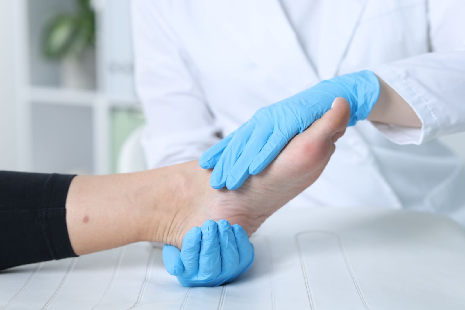 Therapist assessing a patient’s foot and ankle