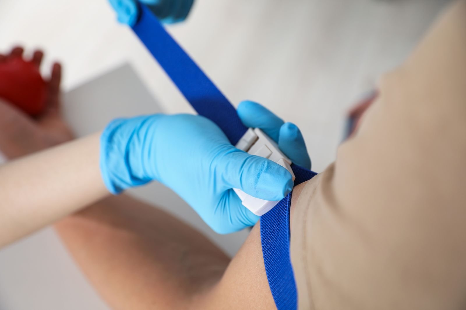 Therapist fitting a support strap during a recovery appointment