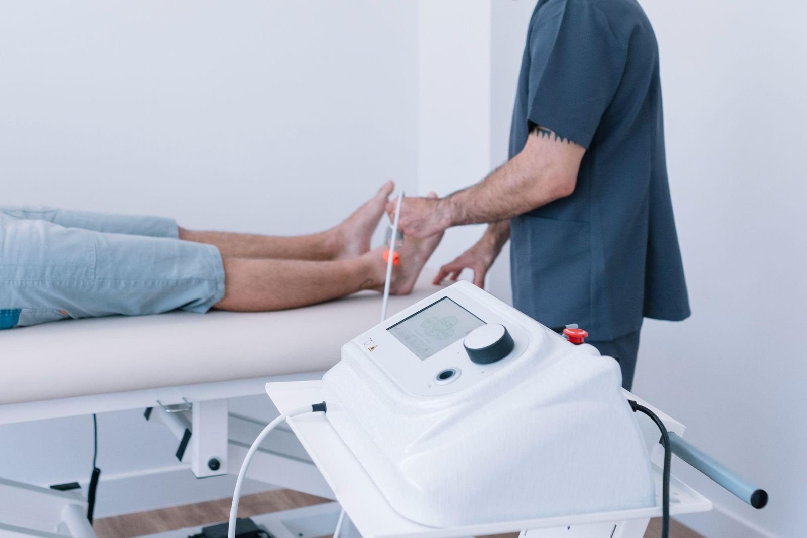 Therapist delivering Class IV high-intensity laser therapy to a patient’s ankle