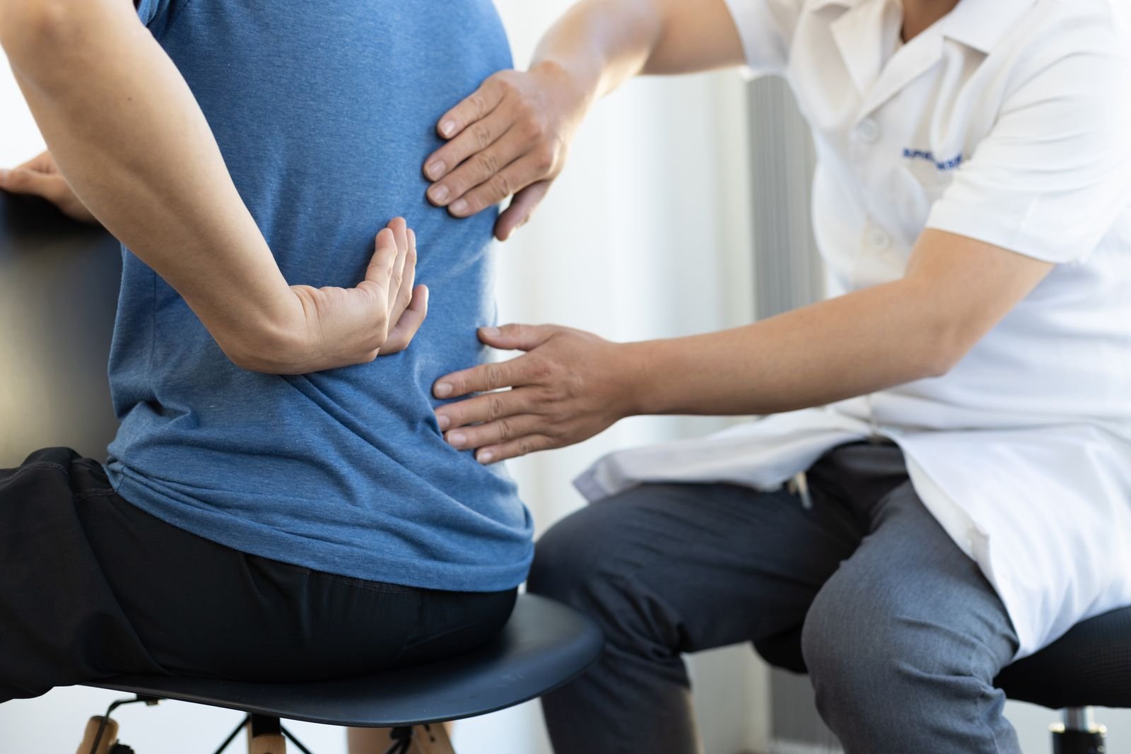 Physiotherapist assessing a patient with low back pain at the New Ray clinic in Abbotsford