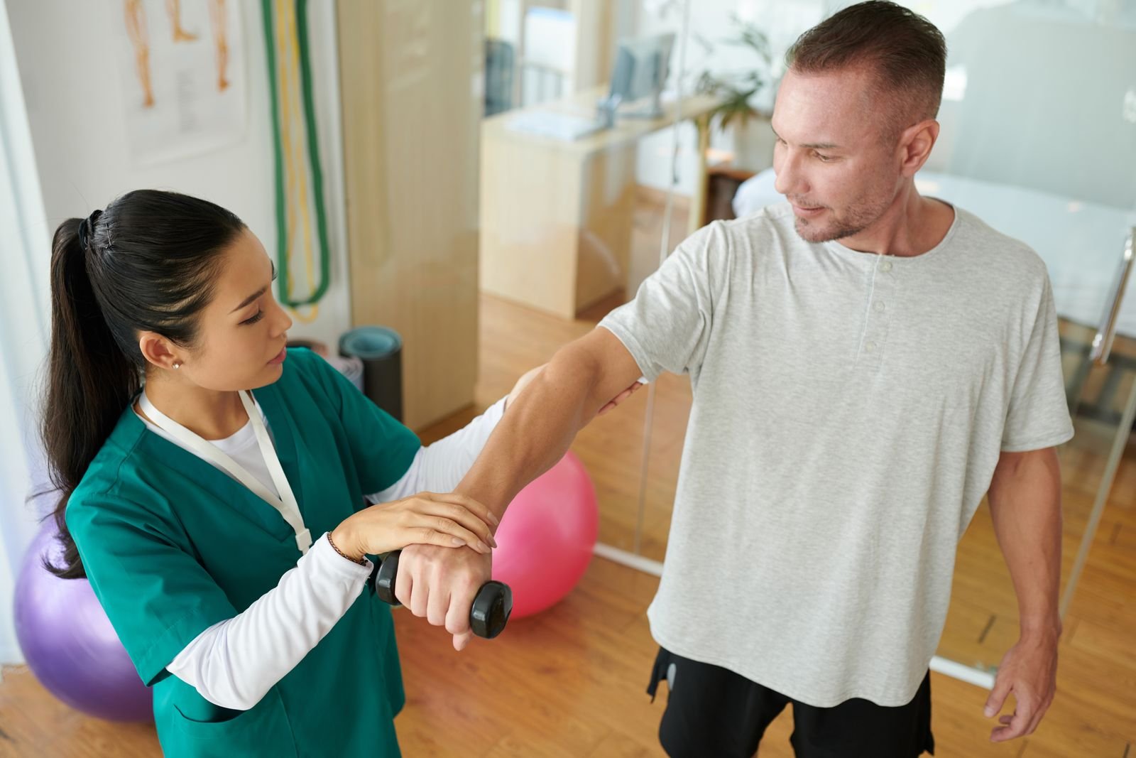 Physiotherapist assessing a patient during their first appointment