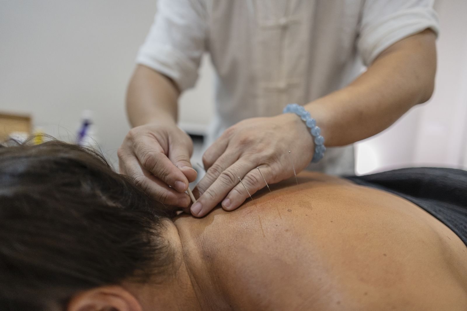 Practitioner applying kinesiology tape to a patient