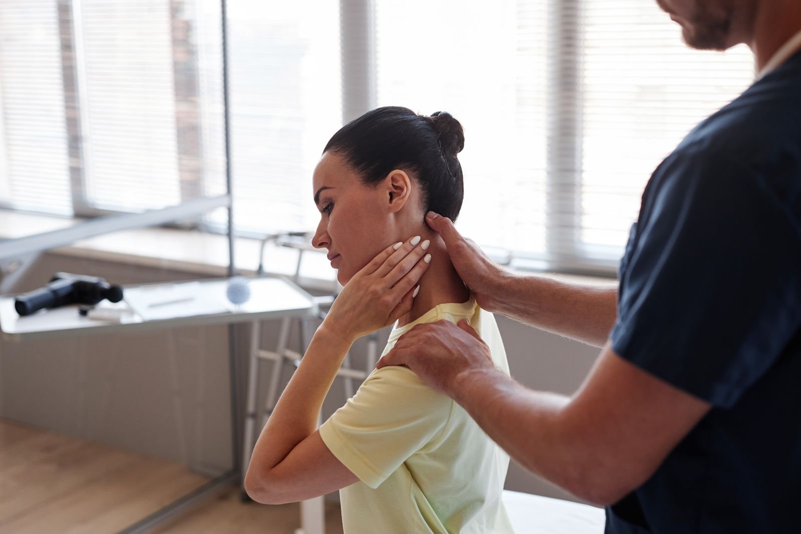 Physiotherapist assessing the upper neck of a patient with headaches at New Ray Physiotherapy and Health Clinic in Abbotsford